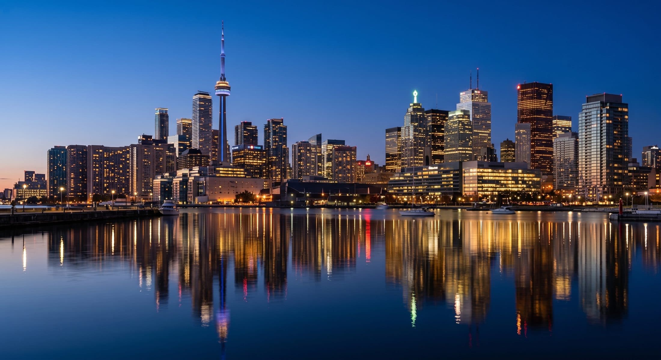 The Toronto skyline at blue hour reflected on calm water